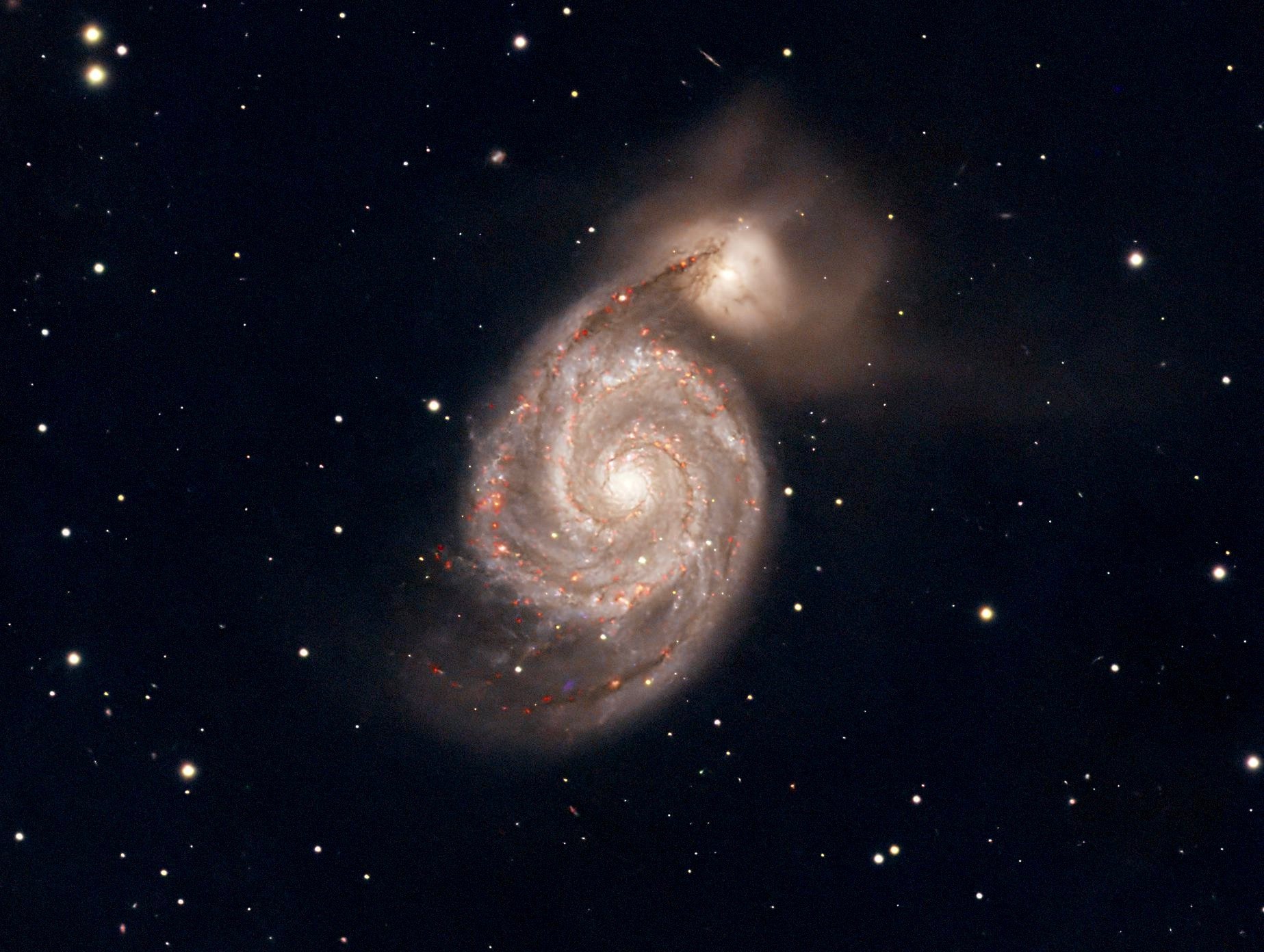 Stunning view of the Whirlpool Galaxy with vibrant spiral arms and surrounding stars.